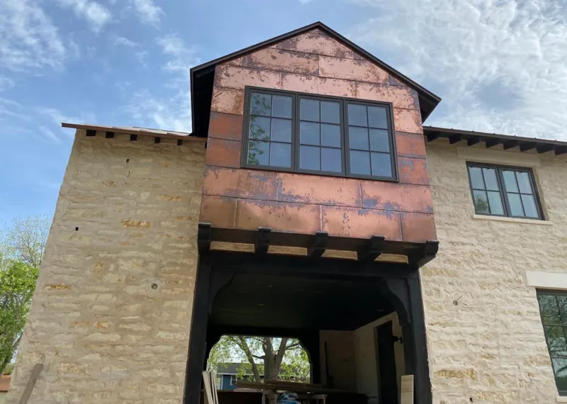 Copper metal panel facade on a stone building for Skylight Installation in Ingleside