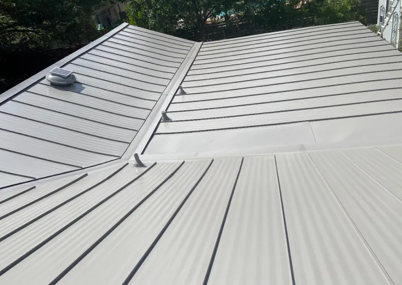 Solar attic fan installed on a metal roof for Roof Ventilation in Ingleside